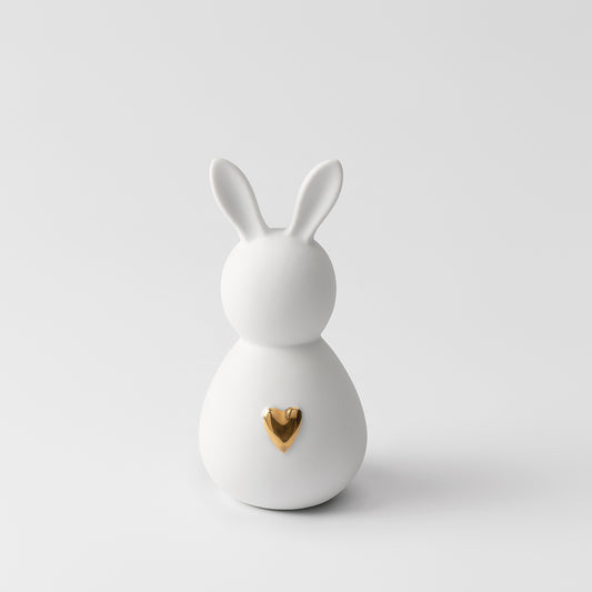 R17467 Porcelain Easter Bunny with gold heart on a white background.