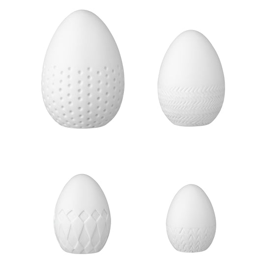 R12068 Four porcelain easter eggs with embossing on a white background
