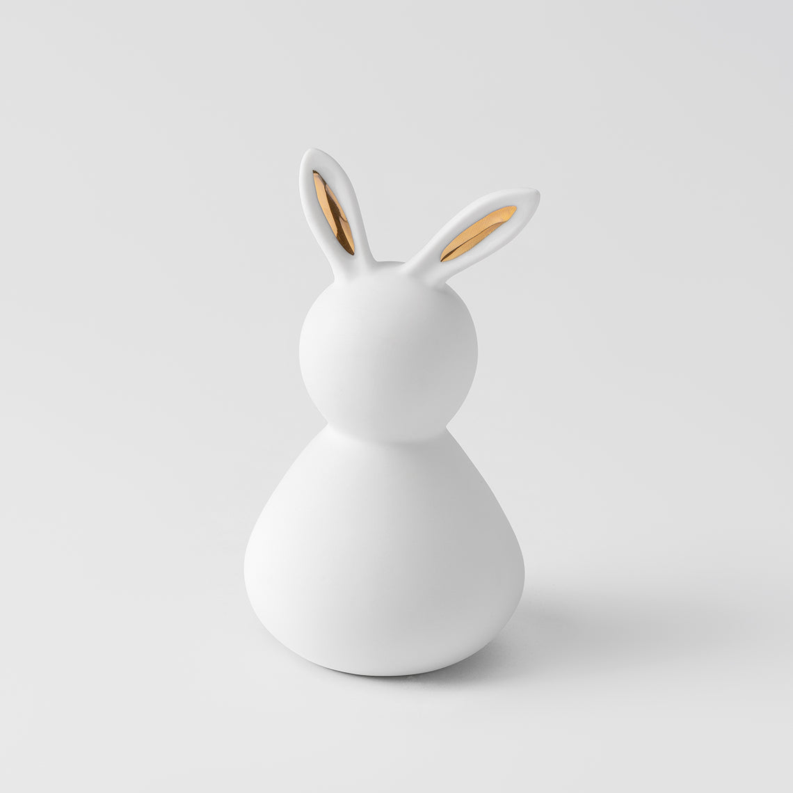 R17494 Porcelain Easter Bunny with Gold Ears on a white background.