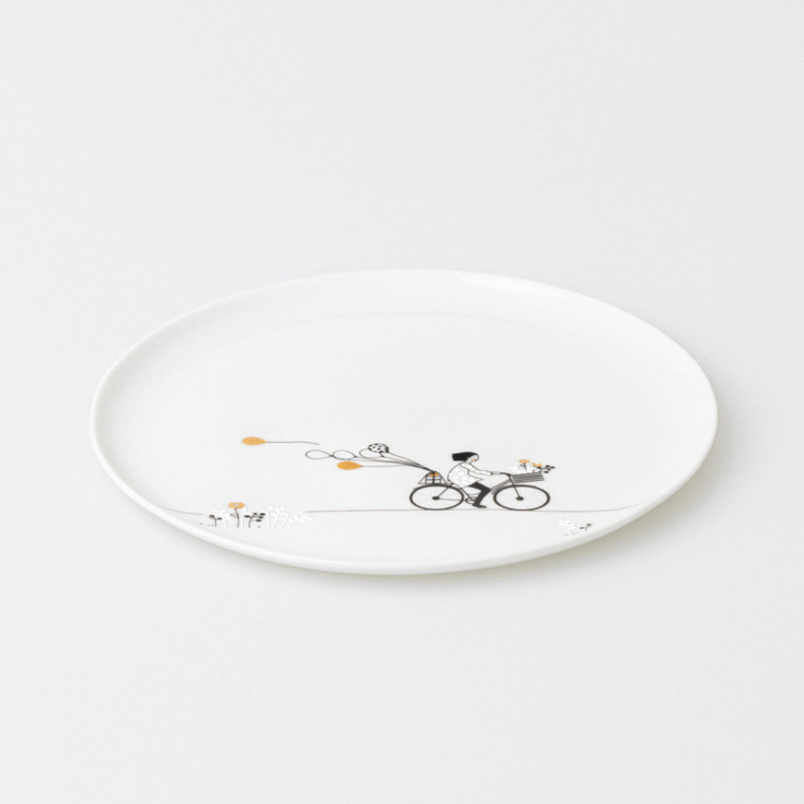 White porcelain plate with a bicycle and dog illustration on a white background