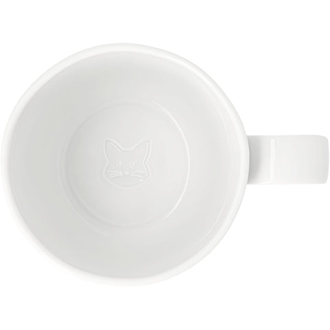 A white porcelain mug shown from a top-down view, featuring a subtle embossed cat face in the center of the interior and a matching white handle on the right.