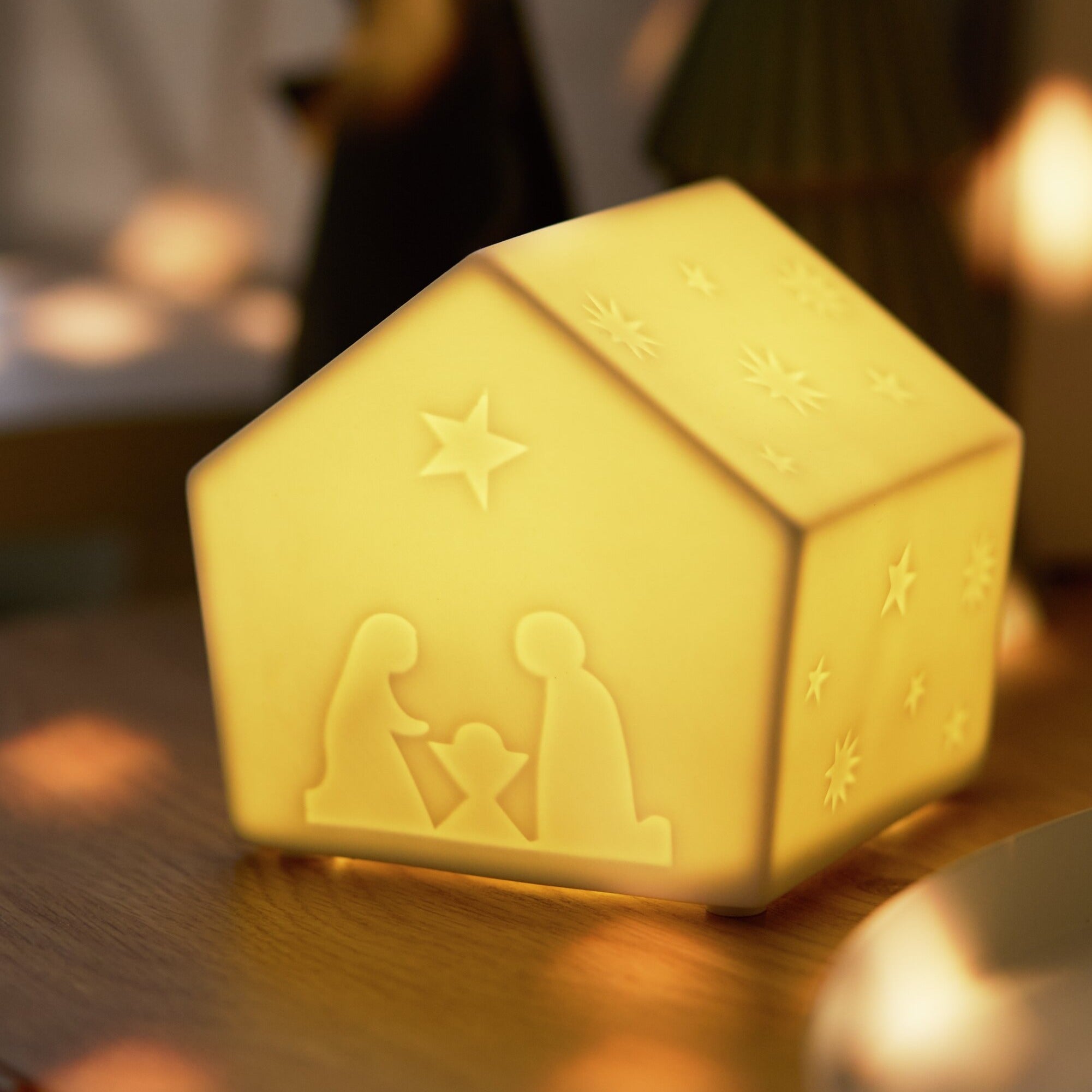 Porcelain LED Nativity House with a very close up view illuminated in a home setting.