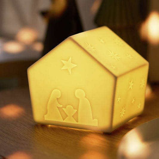 Porcelain LED Nativity House with a very close up view illuminated in a home setting.